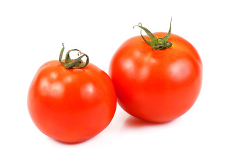 Two tomatoes isolated on a white background
