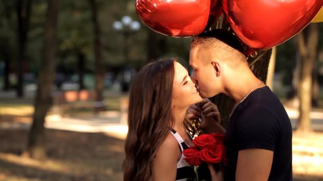Young man romantically meets his girl in a holiday park
