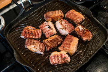 Lamb Meat is frying in a pan.