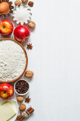 Ingredients for baking on white wooden background. Selection for apple pie or cupcakes
