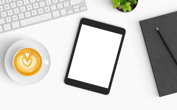 Modern office desk workplace with keyboard, coffee cup, pencil and tablet copy space on color background. Top view. Flat lay style.