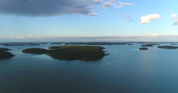 Archipelago, Cinema 4k 360 degree aerial view above a mirroring sea and the finnish saaristo, on a sunny summer evening, in the finnish archipelago of Turku, Varsinais-suomi, Finland