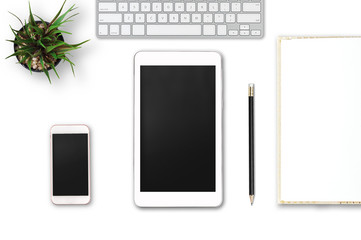 Modern workplace with notebook, smartphone, tablet, pencil and tree copy space on gray background. Top view. Flat lay style.