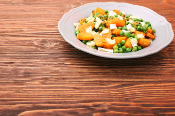 Warm salad with roasted pumpkin, peas and cheese brie