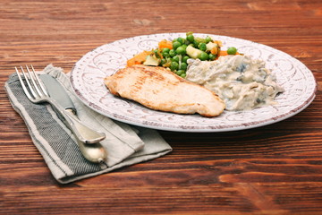 Turkey fillet with mushrooms in cream sauce and vegetables