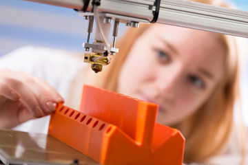 A female student or laboratory assistant in the automation laboratory is debugging the work of the...