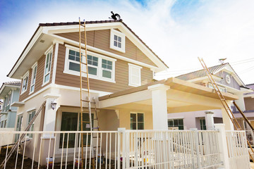 Exterior view of new house under construction and painting.