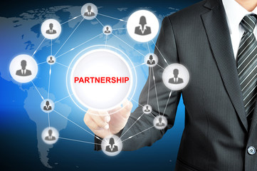 Businessman pointing to PARTNERSHIP word with businesspeople icon network on virtual screen