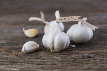 Decorated garlic bulb on vintage wood background