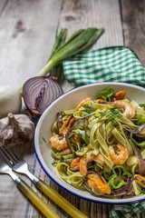 Green tagliatelle with seafood. Mussels; Prawns