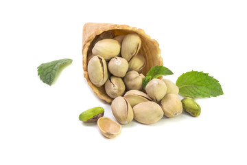 Small crispy pistachios scattered from a horn