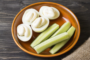 Boiled chicken eggs with mayonnaise in a clay bowl