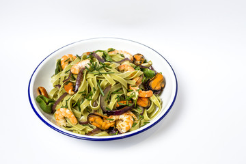 Green tagliatelle with seafood. Mussels; Prawns. Isolated