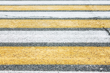 Pedestrian crossing on the asphalt. Textured, concrete surface. Safety on the roads.