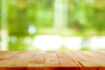 Wood table top on blur green background