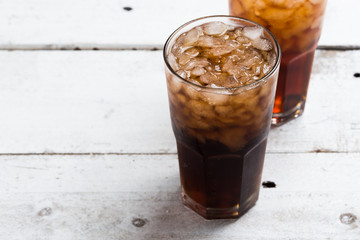 Cola drink glass on white table