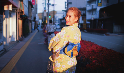 Asian girl tourists in kimono suit under sunset at takayama