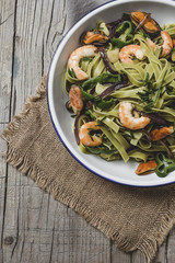 Green tagliatelle with seafood. Mussels; Prawns