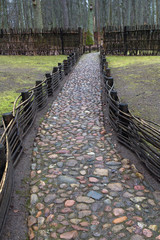 Fence and stone way in Belovezhskaya Puscha in spring