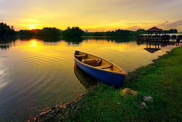 Fototapeta na wymiar Amazing long exposure sunset view with dramatic sky and reflections at Wetland Lake Park, Putrajaya Malaysia. Nature composition.