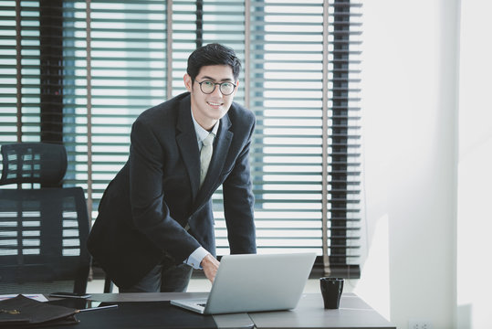 Businessman working at office with laptop on his desk, consultant lawyer concept.