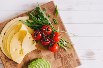 Ingredients for sandwiches laying on a cutting board.