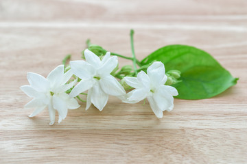 Fototapeta na wymiar Close-up Jasmine flowers on a wood table