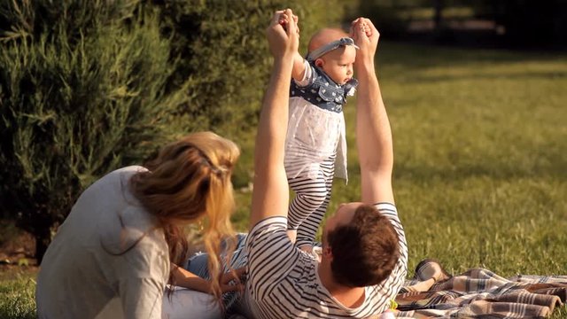 Young parents spending time with their children on a picnic