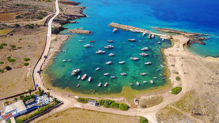 Aerial drone photo of small and safe bay of Parianos with docked fishing boats, Koufonissi island, small Cyclades, Aegean, Greece