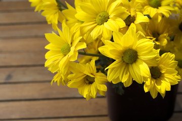 Vase of yellow flowers on the table