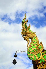 Fototapeta na wymiar Statue serpent On the roof at temple thailand