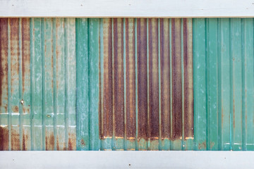 Rusty corrugated metal wall or rusty Zinc grunge and white wooden plank for background.