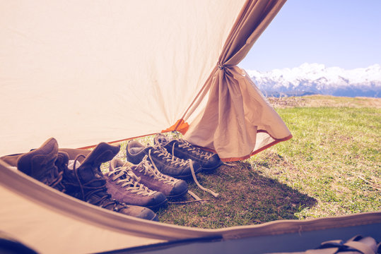 Tourist boots standing next to the entrance to the tent
