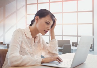 Business woman at a desk using a computer