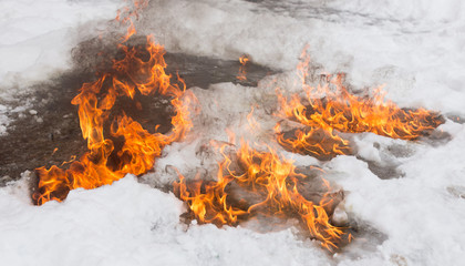 fiery flame on the white snow in winter