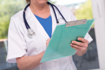 Female doctor holding a clipboard