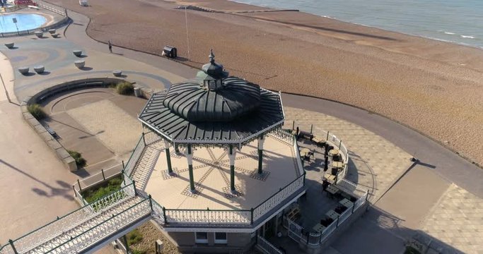 Aerial ascending view of the Victorian bandstand and the ruin of the West pier in Brighton and Hove