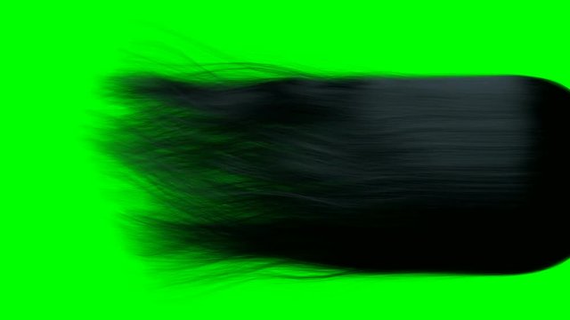 A close up of a long length of black hair blowing and swaying in slow motion before settling on a green screen background