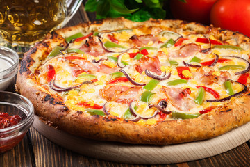 Homemade pizza with bacon, paprika and corn