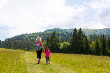 Fototapeta na wymiar mother and little daughter travel in mountains