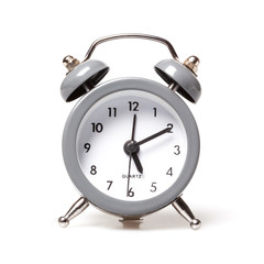 Small analog alarm clocks isolated on white.