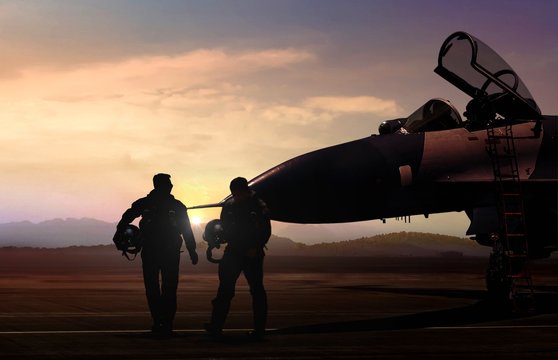 Military Aircraft and pilot  at airfield in silhouette scene