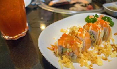 apanese food in set different types of sushi with seaweed salad and gari (ginger) is a healthy food at the upper right of the serving board in japanese restaurant