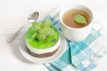 herbal tea with cake on white wooden table