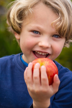 cute 5 year old child eating an apple