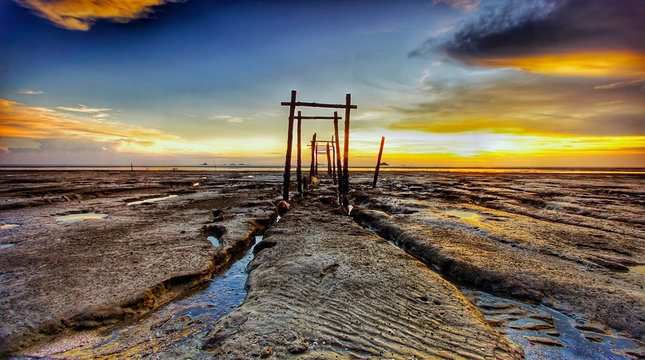 The majestic sunset captured at Pantai Jeram, Selangor, Malaysia during a low tide sea water level. 