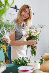 Smiling woman in flower shop