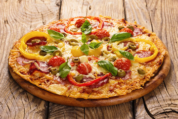 Delicious pizza served on wooden plate