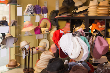 colorful hats hanging on the wall of shop