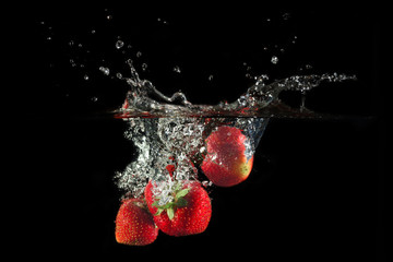 Image of Strawberries splashing into water printed on Printed Glass Worktop Savers